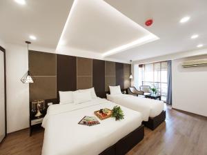 Voodi või voodid majutusasutuse Keypad Hotel - 24 Hang Ga toas