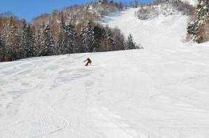 a person is skiing down a snow covered slope at NORTHSTAR Loft in Matsumoto +99 photos