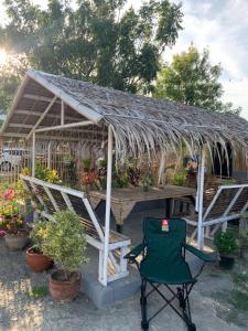 a greenhouse with a table and a chair in front of it at JORA Studio Apartment 1-C in Dagupan