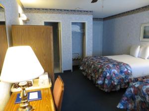 a hotel room with a bed and a table with a lamp at Americas Best Value Inn Tahoe City in Tahoe City