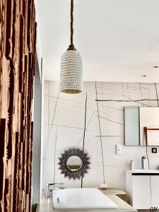 a bathroom with a sink and a mirror at CAPAO Beach Hôtel in Cap d'Agde