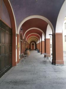 an archway with tables and chairs in a building at Casa San Pietro centro storico in Castagnole Lanze