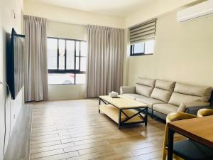 a living room with a couch and a table at Wind Island B&B in Hsing-wen