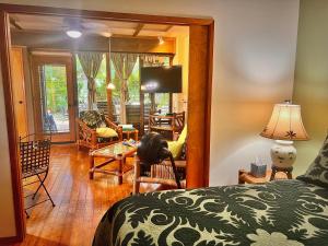 a bedroom with a bed and a living room at Maui What a Wonderful World Bed & Breakfast in Wailea