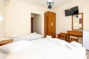 Postel nebo postele na pokoji v ubytování Hotel Alkyon