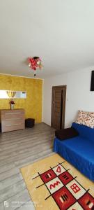 a bedroom with a bed and a rug on the floor at Central City Luxor in Bacău