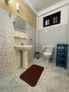a bathroom with a sink and a toilet at Lavila beach cottage in Wadduwa