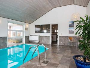 a house with a swimming pool and a kitchen at 10 person holiday home in Henne in Henne
