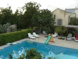 a swimming pool with a slide and a playground at Agriturismo Ruvitello in Misterbianco