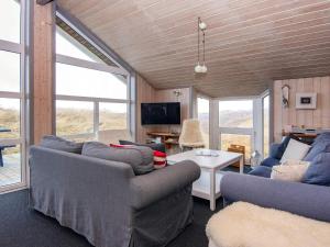 A television and/or entertainment centre at 10 person holiday home in Henne