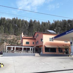 a building with tables and chairs in a parking lot at Nossa Senhora do Pranto in Ferreira do Zêzere