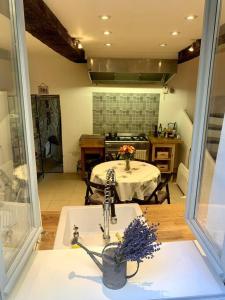 a kitchen with a table and a sink in a room at La Petite Cave in Saignon