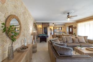 a living room with couches and a stone wall at Piedra Villa in Troïanáta