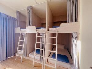 a room with four bunk beds in it at Wind Island B&B in Hsing-wen