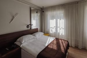 a bedroom with a large bed and a window at Hotel Skeppsholmen, Stockholm, a Member of Design Hotels in Stockholm
