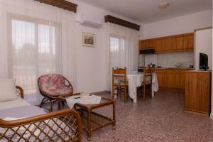 a living room with a couch and chairs and a table at vickys family house in Stavros