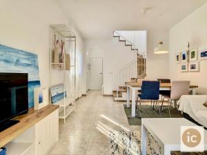 a living room with a couch and a table at La Vela Estartit Rental in L'Estartit