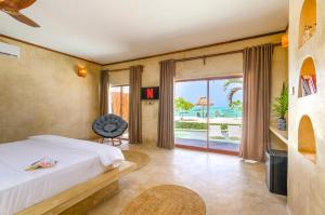 a bedroom with a bed and a view of the ocean at Safaya Luxury Villas - Adults only in Nungwi
