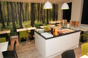 a buffet in a restaurant with trees in the background at The Omega Hotel in London