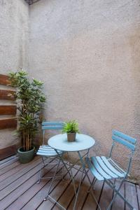 two chairs and a table and a table and two plants at BrandNewChainBridgeHome for 2-FastWiFi/AC/SmartTV in Budapest