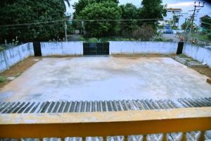 a large concrete slab in front of a fence at Smith 5BHK Villa in Puducherry