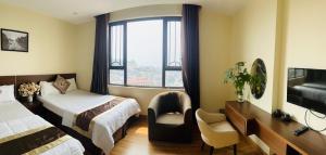 a hotel room with two beds and a window at Song Kieu Hotel - Self check-in in Ha Long