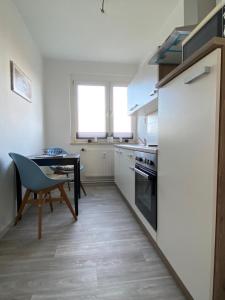 a kitchen with a table and a dining room table at Gästewohnung KL WZL 31 8 