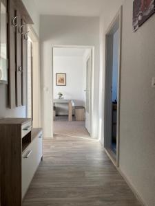 a white room with a hallway with a table at Gästewohnung KL WZL 31 8 