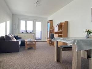 a living room with a couch and a table at Gästewohnung KL WZL 31 8 in Klein Wanzleben