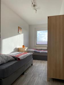 a bedroom with two beds and a window at Gästewohnung KL WZL 31 8 
