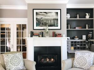 a living room with a fireplace with two chairs at Inn on Randolph in Napa