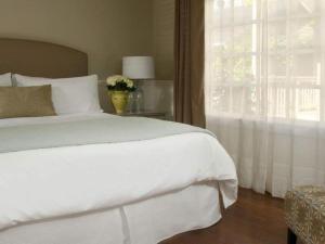 a bedroom with a white bed and a window at Inn on Randolph in Napa
