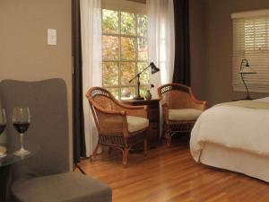 a bedroom with a bed and chairs and a window at Inn on Randolph in Napa