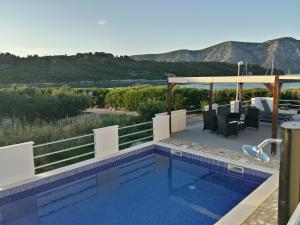 a swimming pool with a view of the mountains at Fei Fei Apartments 2 in Račišće