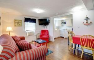 uma sala de estar com um sofá e uma mesa em Carriage House Motel Cottages & Suites em Wells