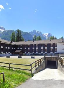 een schoolgebouw met een hek en een hek bij Appartamento 6 posti sulle piste a Folgarida Cond. Carlo Magno in Folgarida