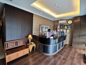two people standing at a bar in a restaurant at Goodhope Hotel Shah Alam in Shah Alam