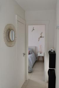 a bedroom with a bed and birds flying over it at Lucaya in Koksijde