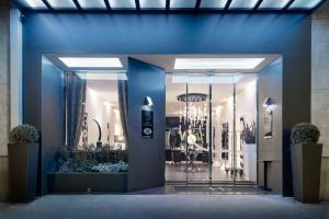a store front with a blue wall and a glass door at LHP Napoli Palace & SPA in Naples