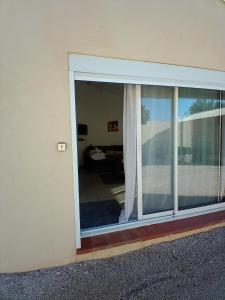 eine Glasschiebetür mit Blick auf ein Wohnzimmer in der Unterkunft Studio entre Aix et Marseille in Bouc-Bel-Air