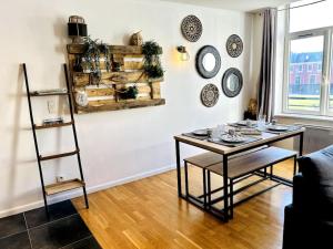 a living room with a table and a shelf at Vieux-Lille - Superbe appartement fonctionnel in Lille +6 photos
