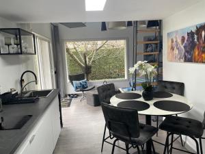 a kitchen and dining room with a table and chairs at MealSaveurs & SPA in La Buisse