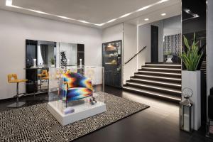 a lobby with a chair in a glass case at LHP Napoli Palace & SPA in Naples
