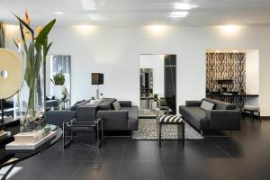 a living room with a couch and chairs and a table at LHP Napoli Palace & SPA in Naples