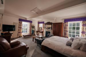 a bedroom with a large bed and a living room at Fernhill House- Beautiful period property with 5 bedrooms and lovely views in Laugharne
