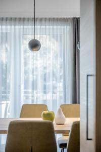 a dining room with a table with a green apple on it at Camping Sölden Apartments in Sölden