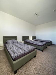 three beds are lined up in a room at Gästewohnung KL. WZL 31_7 