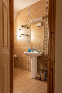 a bathroom with a sink and a mirror at Atlantic View Cottages in Doolin