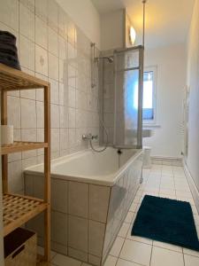 a bathroom with a tub and a shower in it at Gästewohnung KL. WZL 31_7 