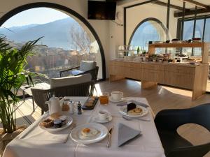 a table with breakfast food on it in a restaurant at Guest House Le Cassandre in Sondrio